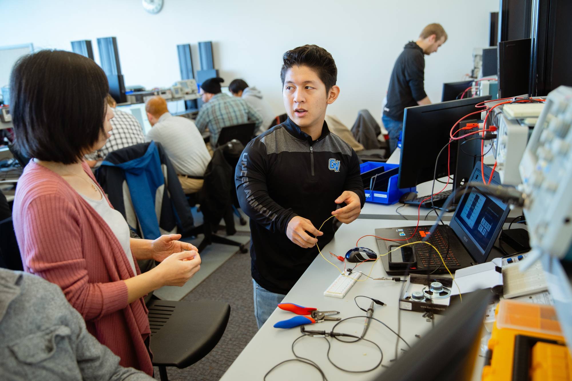 A student and professor work together in a lab classroom